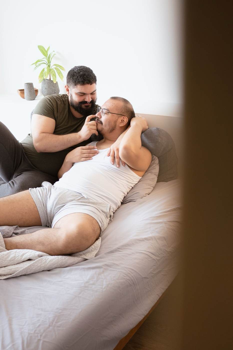 Two men sharing a playful moment indoors