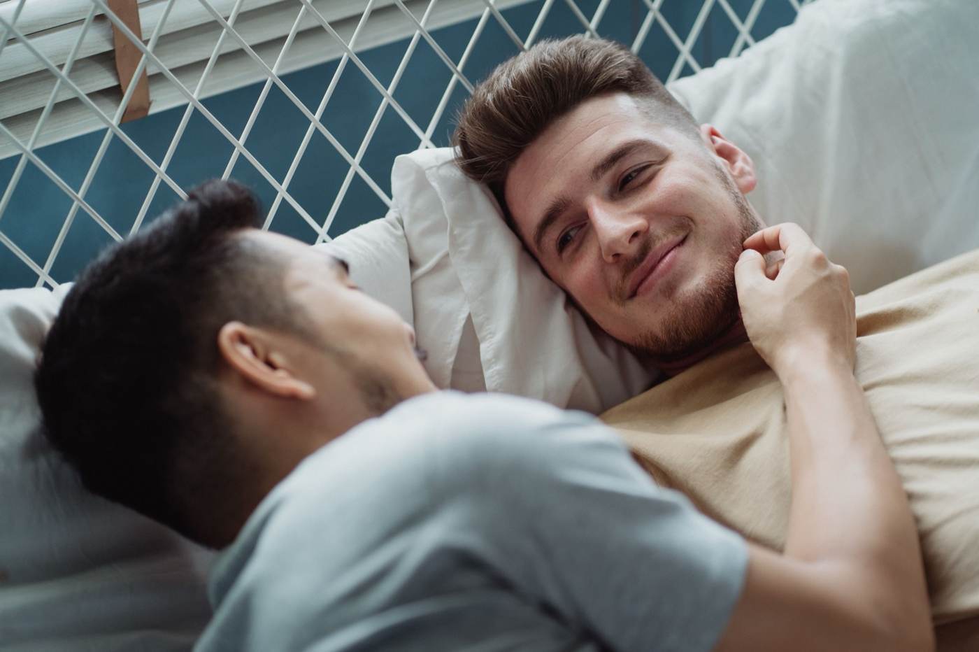Two men in a tender bedside moment, close and calm